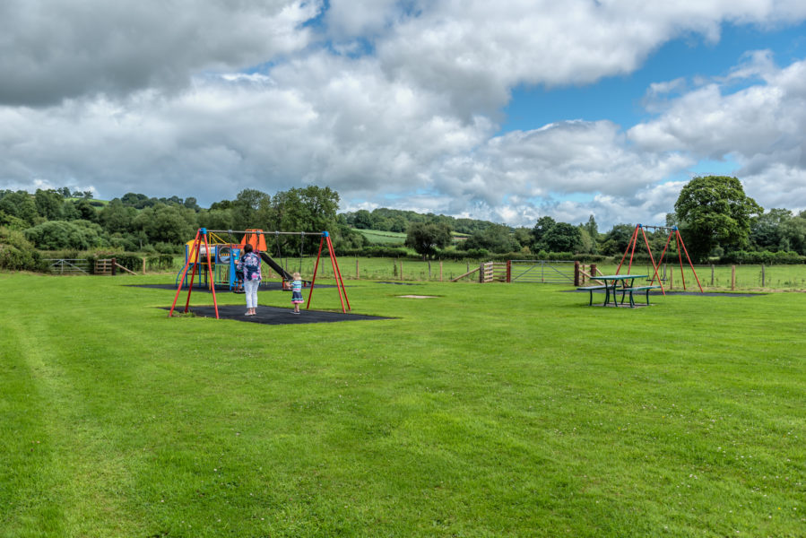 The Caravan Parks playground facilities with swings, picnic benches, a slide and climbing frame and more