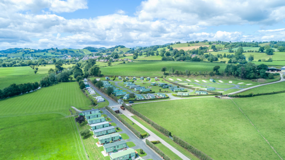 An aerial view of the Welsh countryside with Bryn Vyrnwy Caravan park on two sides of the road